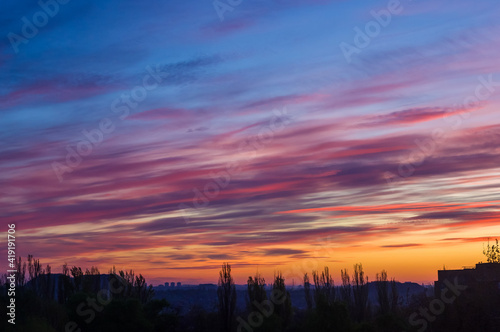 Landscape with dramatic light - beautiful golden sunset with saturated sky and clouds.