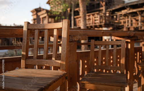 Wooden chairs on the summer terrace close up.