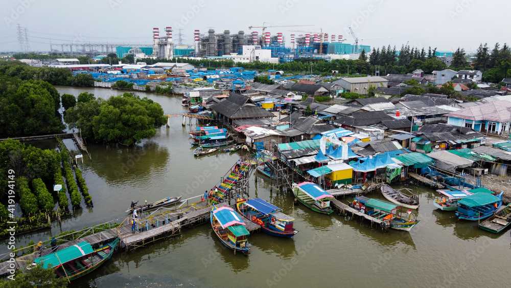 Aerial view of fisherman village and mangrove forest in rainy season.
