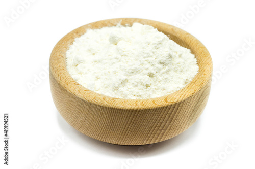 flour in wooden bowl isolated on white background