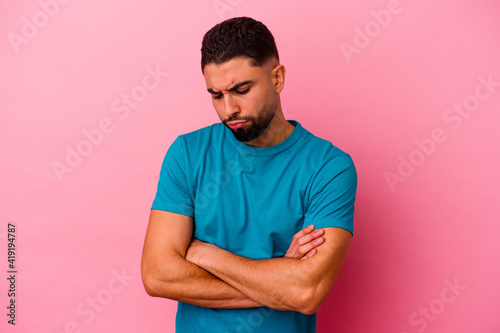 Young mixed race man isolated on pink background