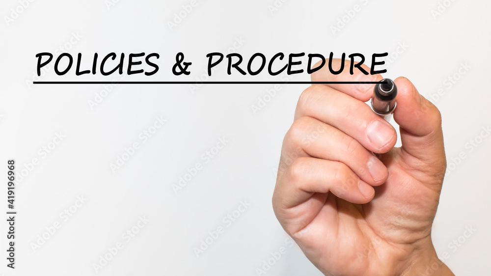 the hand writes text POLICIES AND PROCEDURE with a marker on a white background. business concept the hand writes text POLICIES AND PROCEDURE with a marker on a white background. business concept