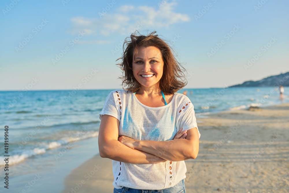 Portrait of happy smiling confident middle aged woman on beach Portrait of happy smiling confident middle aged woman on beach