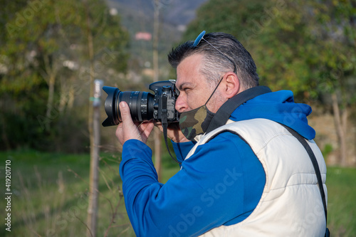One caucasian male photographer taking pictures of a landmark