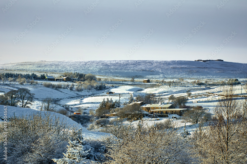 Farmland and homes and a snowy view in the Yorkshire Dales at 900ft