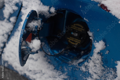 Fototapeta Naklejka Na Ścianę i Meble -  Opened gas tank cap on a car in winter 