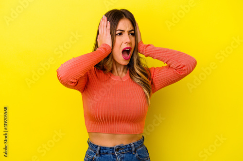 Young caucasian woman isolated on yellow background