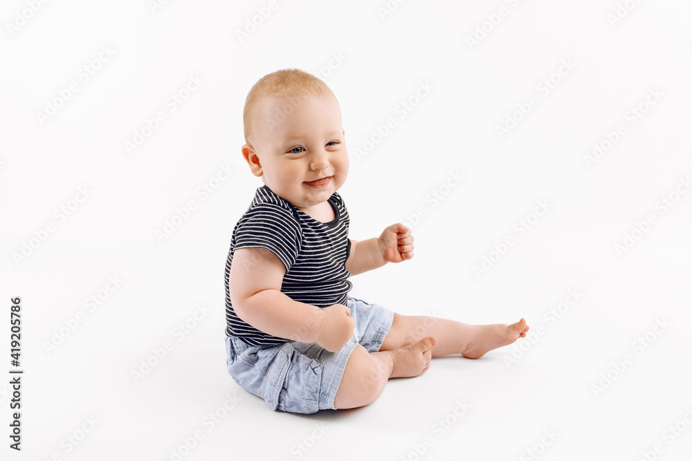 Little happy boy, kid is played on isolated white background Little happy boy, kid is played on isolated white background