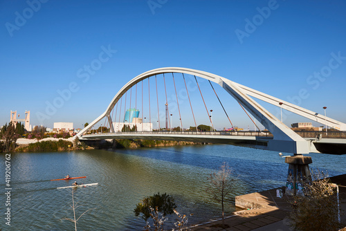Rowboats in the Guadalquivir river and La Barqueta bridge, Seville, Spain