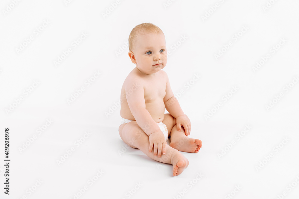 Happy baby in diaper sitting on isolated white background Happy baby in diaper sitting on isolated white background