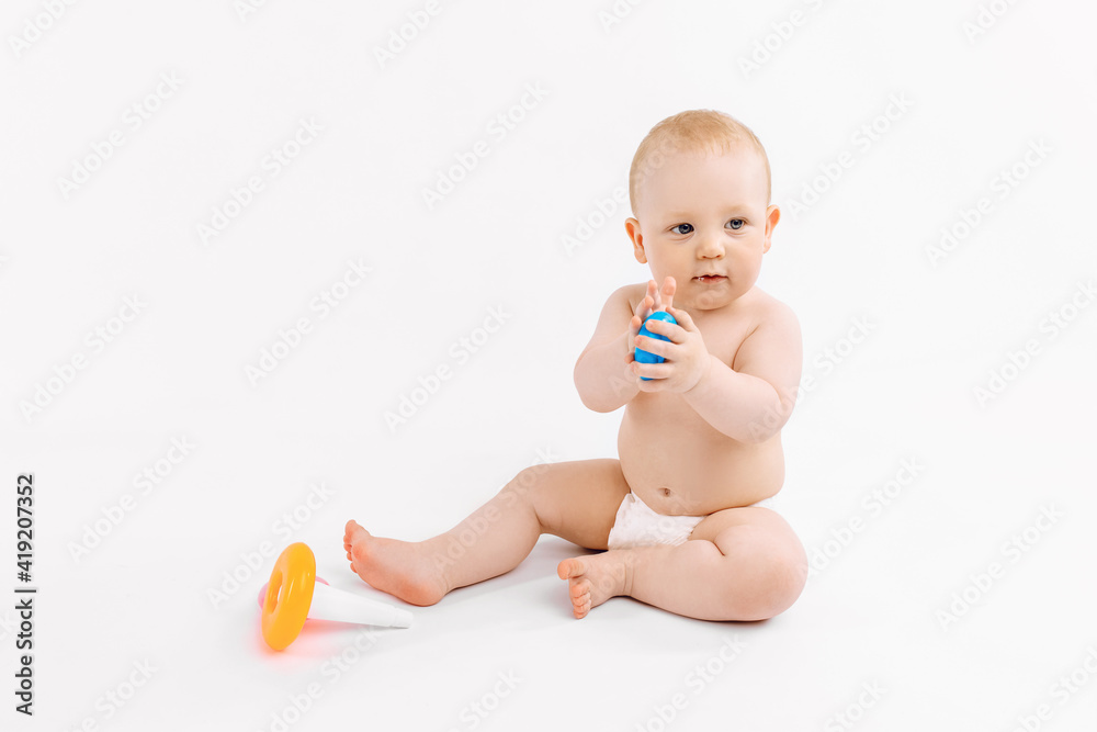 Little kid playing with baby pyramid on white background Little kid playing with baby pyramid on white background