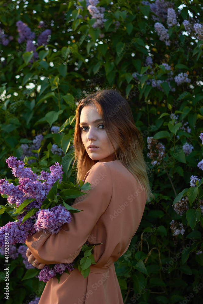 Young beautiful girl with a bouquet of lilacs. Walk in the fresh air. Freshness, spring and flowers concept. Young beautiful girl with a bouquet of lilacs. Walk in the fresh air. Freshness, spring and flowers concept.