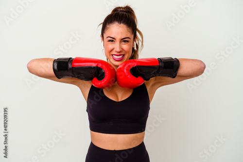 Young caucasian woman fighting with boxing gloves isolated on white background © Asier