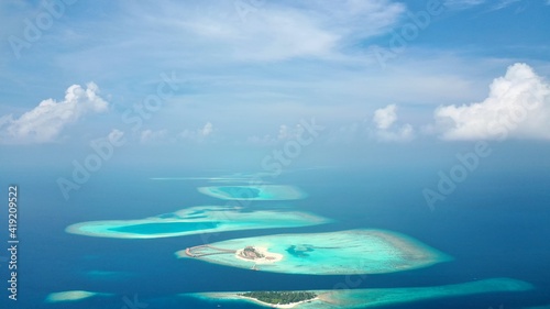 Fototapeta Naklejka Na Ścianę i Meble -  Bird's eye view of tropical islands in the ocean. View of the islands from a drone. Maldives, Thinadhoo (Vaavu Atoll), Dhigurah