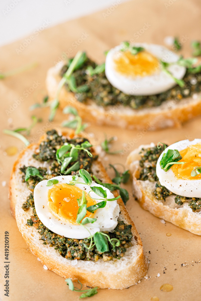 Egg and green pesto sandwiches. Stock Photo | Adobe Stock