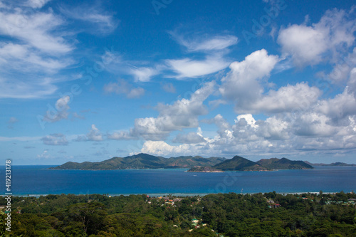 Panorama over La Digue Island from the hill with the ocean and cloudy sky