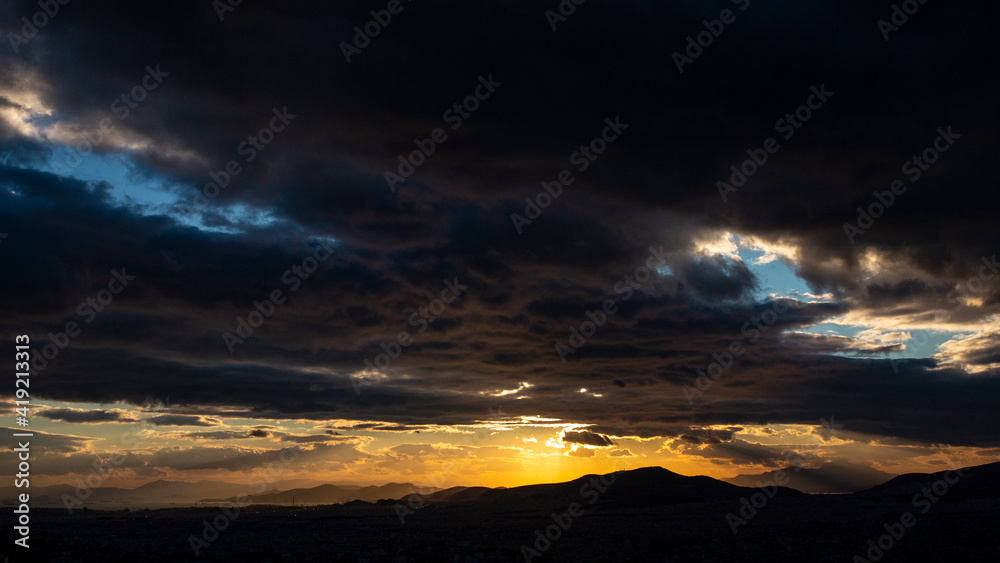 Sunset in Athens of Greece with two holes in the sky