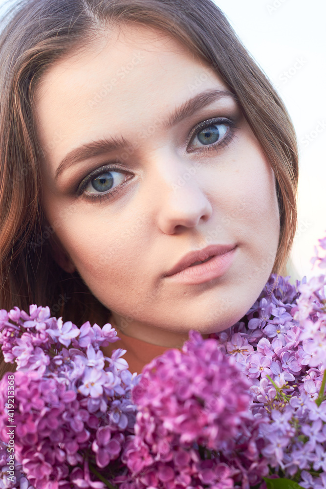 Young beautiful girl with a bouquet of lilacs. Walk in the fresh air. Freshness, spring and flowers concept. Young beautiful girl with a bouquet of lilacs. Walk in the fresh air. Freshness, spring and flowers concept.