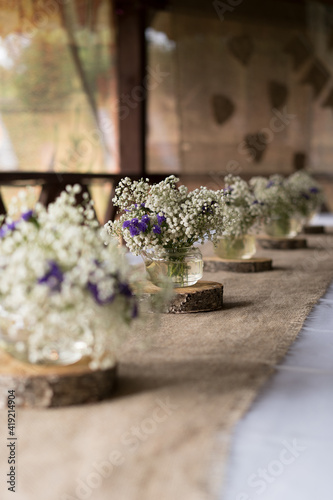 Festive wedding decoration of table with flowers. Rustic or boho style