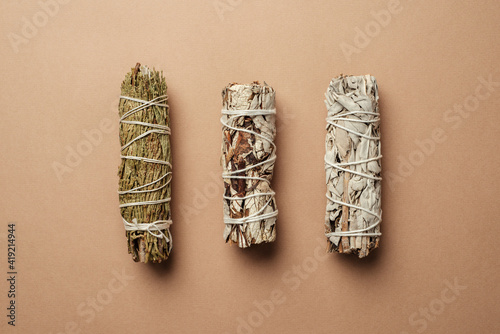 Set of incense for fumigation of premises. Branches of white sage with cedar tied in a bunch. View from above. Organic holy plant incense from Latin America. Close-up color photo.
