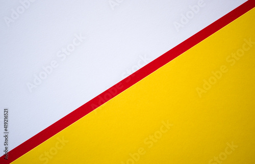 Diagonally divided textured colored paper background. White and yellow template with red line