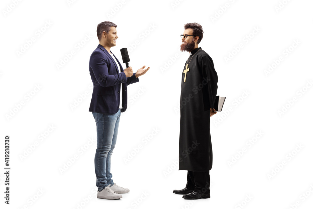 Full length profile shot of a reporter with a microphone talking to a catholic priest Full length profile shot of a reporter with a microphone talking to a catholic priest