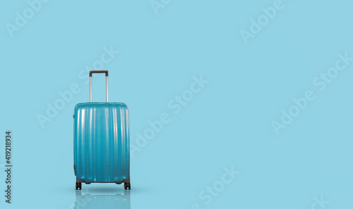Blue stylish travel suitcase isolated on blue background.