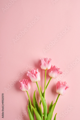 Pink tulip flowers bouquet on front of pink background. Easter Greeting card. With copy space. © kasia2003