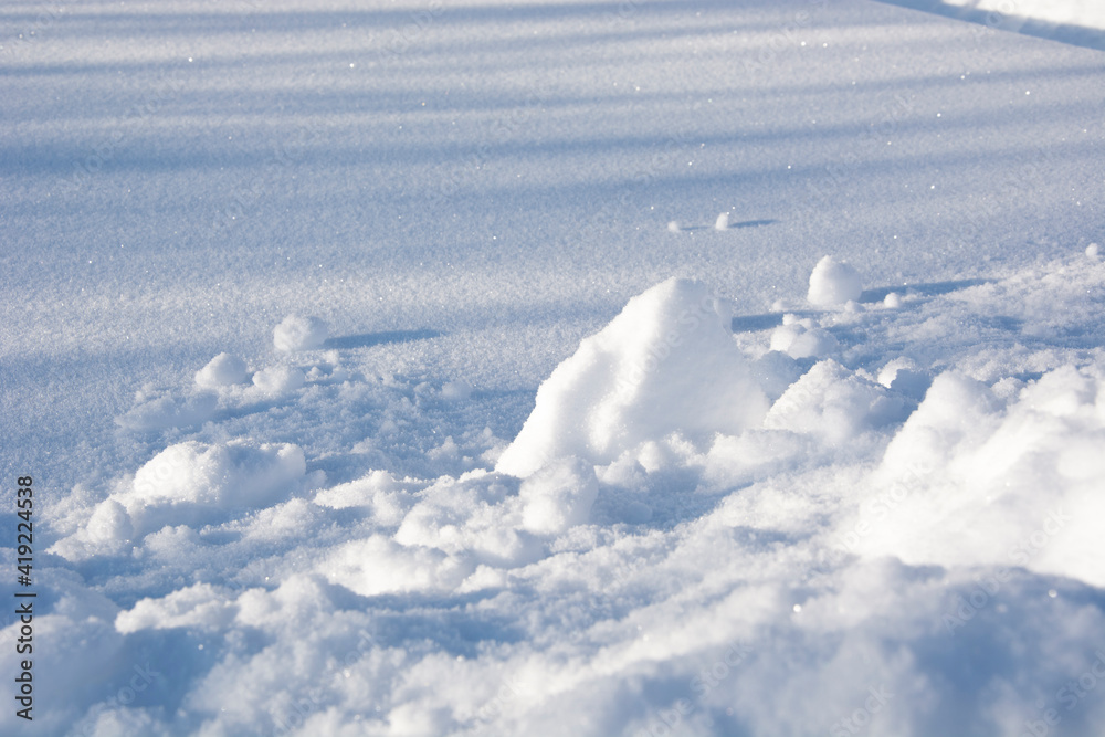 Snow. Snow drifts close up. Snowy surface during the day. Winter snow texture.