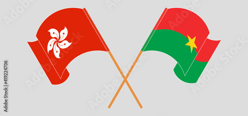 Crossed and waving flags of Hong Kong and Burkina Faso