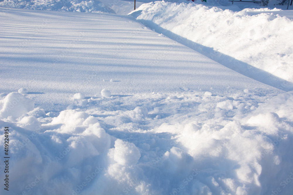 Snow-covered vegetable garden in winter. High snowdrifts in the country. Winter paths in the garden. Snow-covered vegetable garden in winter. High snowdrifts in the country. Winter paths in the garden.