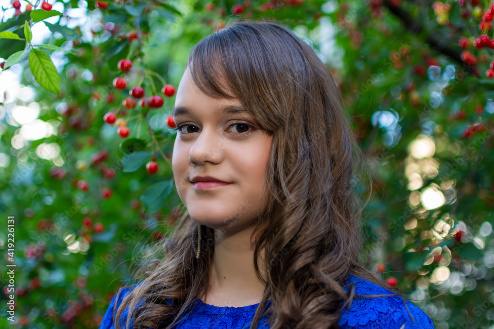 Portait of cute teen girl with makeup posing in cherry garden Portait of cute teen girl with makeup posing in cherry garden