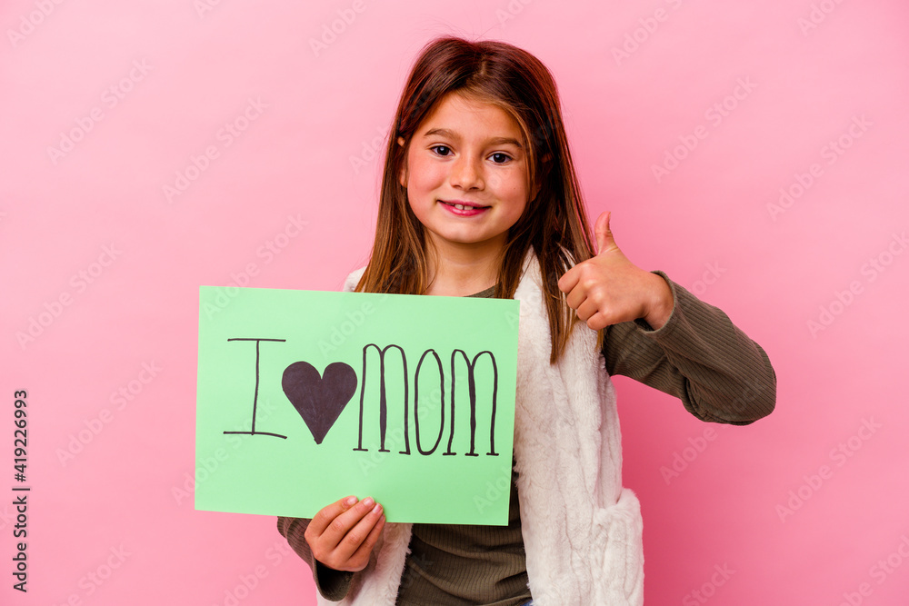 Little girl holding an I love mum placard isolated on pink background Little girl holding an I love mum placard isolated on pink background