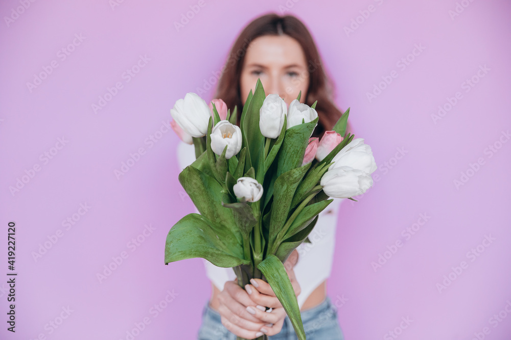 Happy spring young woman with tulips flowers