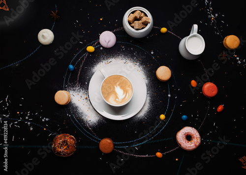 Fototapeta Naklejka Na Ścianę i Meble -  cup of coffee,  donuts, macaroons, sugar, milk cream jug and cakes on black background look like coffee system 