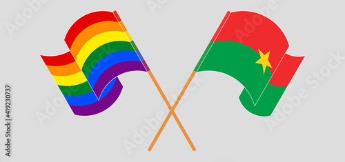 Crossed and waving flags of LGBTQ and Burkina Faso