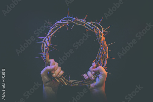 Fotografering two hands hold crown of thorns