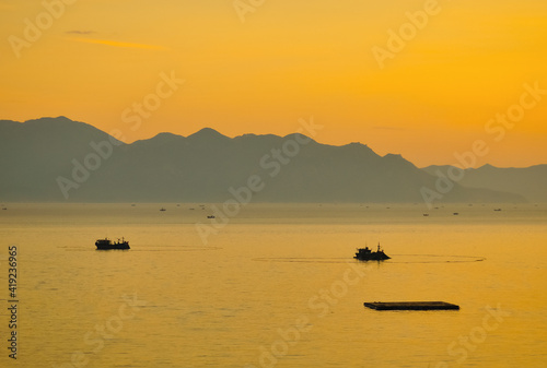 fishing ships in a mountainous bay