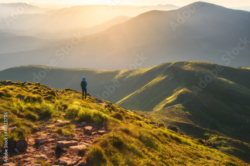 Girl on mountain peak with ...