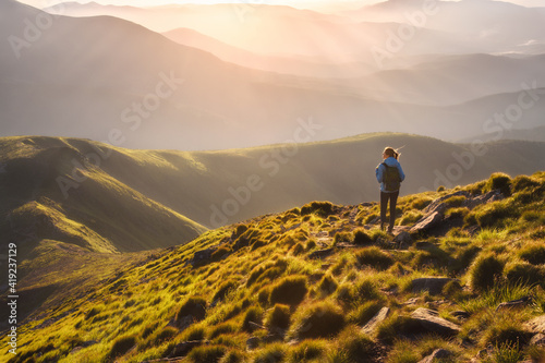 Girl on mountain peak with ...