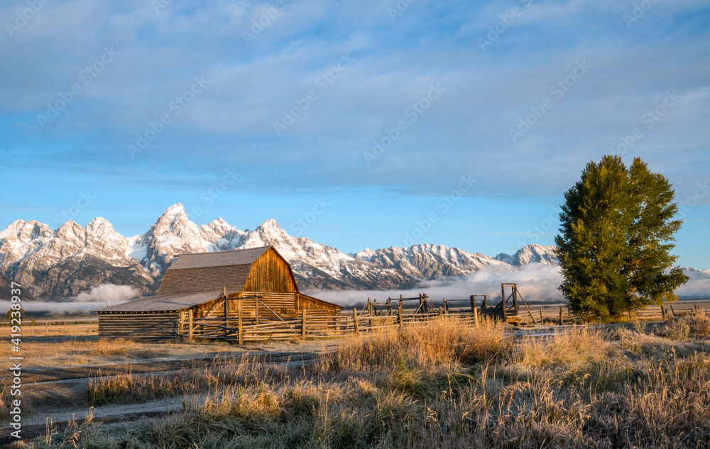 autumn at the historic Moulton barn in Mormon Row with snow capped mountain on the background in Grand Teton national Park in Wyoming.
