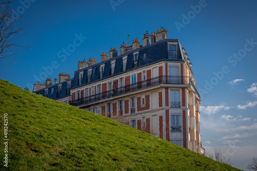 Paris, France - 02 26 2021: Montmartre district. A building facade behind the hill