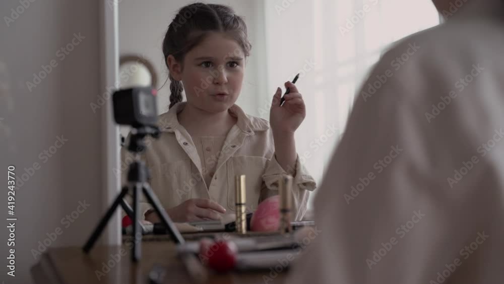 girl child blogger broadcasts live online and writes a blog about teen makeup and cosmetics. close-up. High quality 4k footage girl child blogger broadcasts live online and writes a blog about teen makeup and cosmetics. close-up. High quality 4k footage