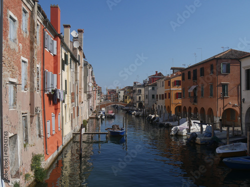 Chioggia, Vena Canal with colorful ancient buildings on both sides and crossed by ancient bridges
