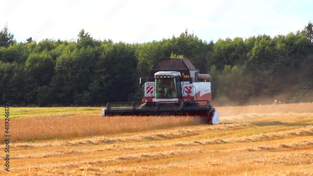 The work of the combine. The combine harvester collects wheat . Harvesting. Future bread. Working equipment in the field. Summer harvest. The work of the combine. The combine harvester collects wheat . Harvesting. Future bread. Working equipment in the field. Summer harvest.