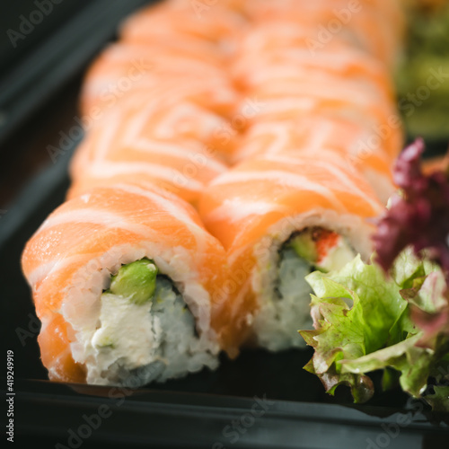 Close-up of fresh rolls and sushi set. Japanese cuisine. Tasty food. Fish and rice.