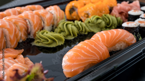 Close-up of fresh rolls and sushi set. Japanese cuisine. Tasty food. Fish and rice.