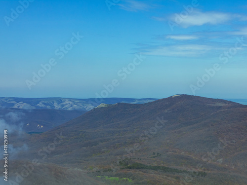 clouds, blue sky, haze over the mountains.