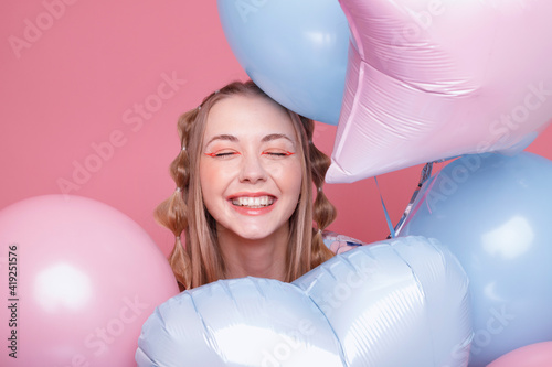 Happy woman smiles in balloons