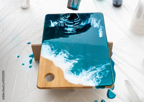 фотографія serving board, decorated with epoxy resin, imitation of the sea